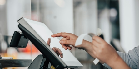 a person is using a pos machine in a store